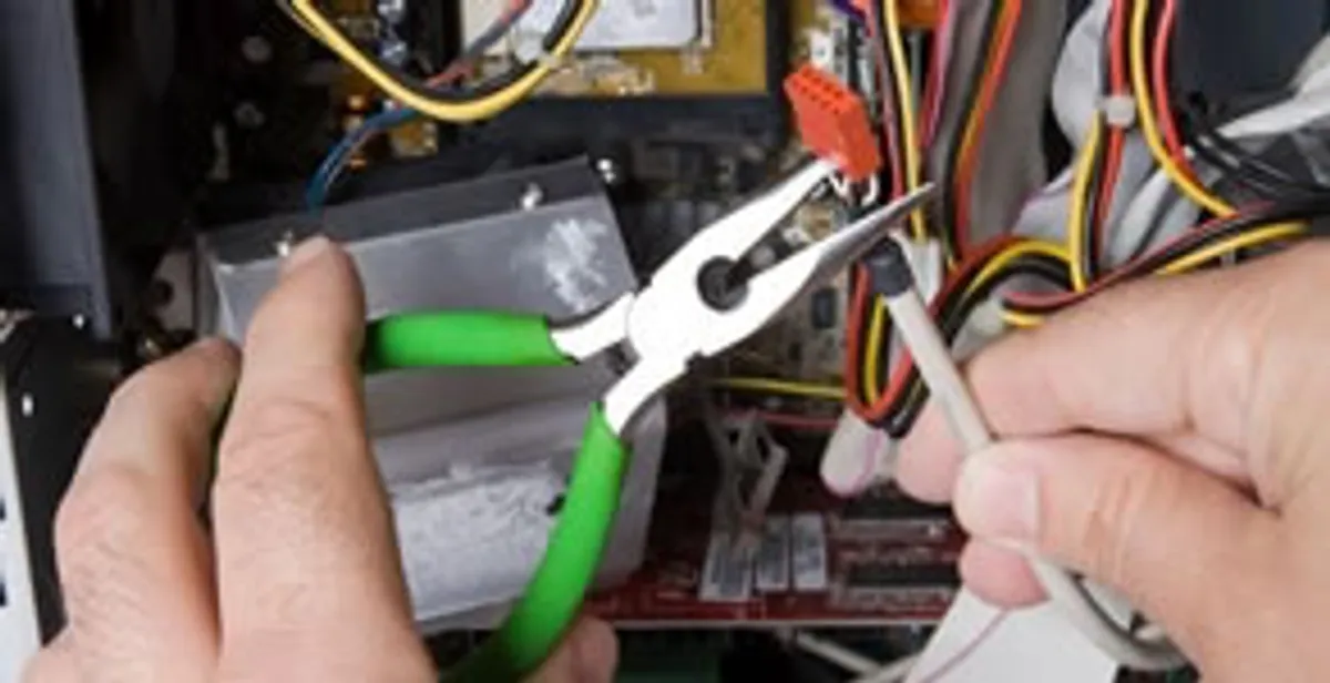 Licensed electrical contractor performing electrical repair with tools in Harrisburg, NC