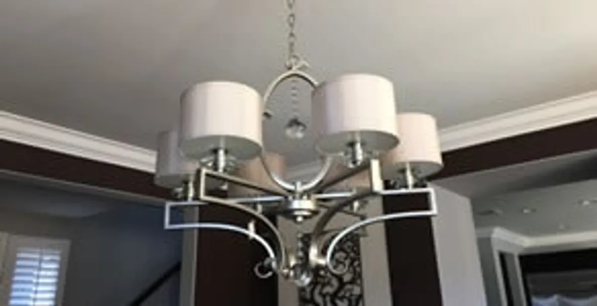Modern chandelier installation with multiple light fixtures in Charlotte, NC